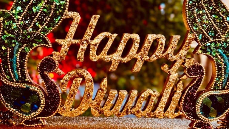 Decorative Happy Diwali sign with colorful lights and intricate designs.